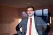 © Red Riding Hood - Portrait of a businessman standing in the office and looking from the silent room.
