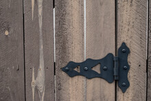 Wood And Black Metal Hardware On A Gate