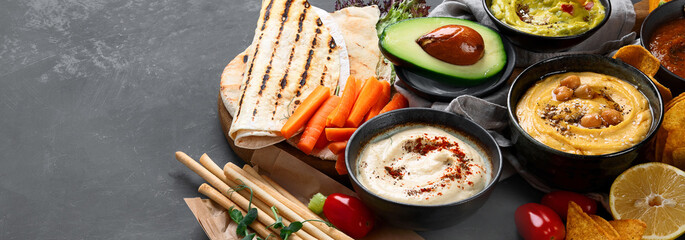 Wall Mural - Different kinds of hummus dips with snacks