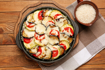 Baking dish with tasty rice casserole on table