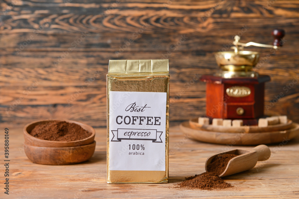 Pack and scoop with coffee on wooden background