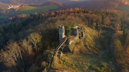 Wall Mural - Aerial drone view of the Zubstejn ruined castle on the hill, Czech Republic. Unidentifiable tourist are climbing to ruindec castle. Autumn weather during sunset.