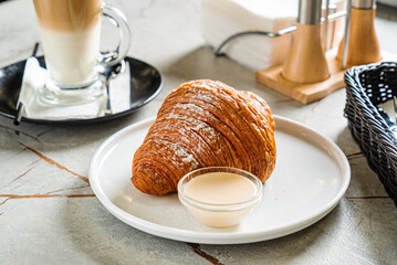 croissant and cappuccino in the cafe