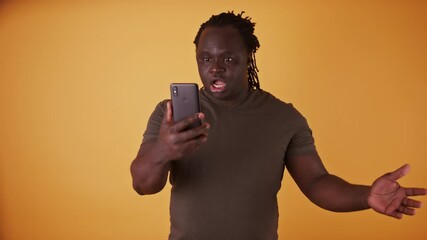 Shocked african american black man reading a text message on the smartphone. High quality 4k footage