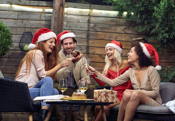 Wall Mural - Group of happy young people celebrating; House party concept