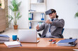© Elnur - Young male employee wearing virtual glasses in the office