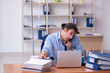 © Elnur - Young male employee suffering at workplace