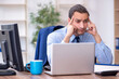© Elnur - Young male employee unhappy with excessive work