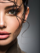 Closeup Portrait Of A Beautiful Young Fashion Woman With Glamour Makeup Posing At Studio.