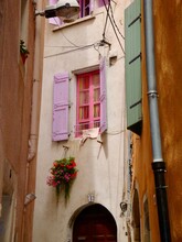 Pink Window And Shutters On Old House