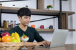 © Jack Fotografo - Young Asian man is sitting in a modern dining room