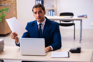 Young male employee working in the office