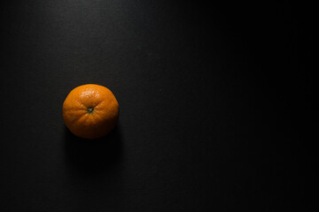 Top view of an orange isolated on a black background