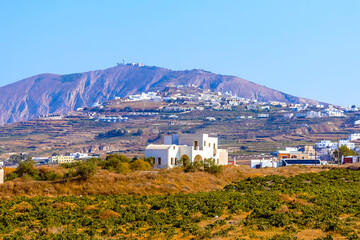Wall Mural - The view from Megalochori across vineyards towards Mount Profitis Ilias in Santorini in summertime