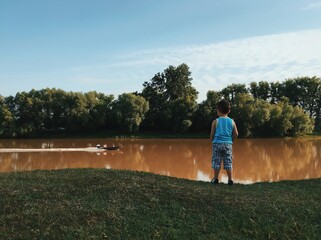 Wall Mural - child on the riverbank