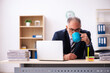 © Elnur - Old businessman drinking coffee at workplace