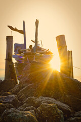 Beautiful view on sunrise with wooden boat as a subject at Kenjeran beach,Surabaya.Indonesia