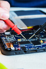 close up image of smart phone and tablet repair, in technology lab.