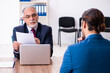 © Elnur - Young male candidate employee meeting with old recruiter