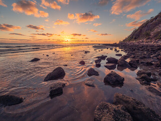  Beautiful Seaside Sunrise with Cloud Reflections and Rocks