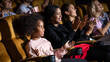 © NVB Stocker - Happy family watching movie in cinema theatre. Happy family time in holiday