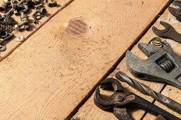 Wall Mural - Old vintage household bolts, nuts and hand tools still life on a wooden background in a DIY and repair concept