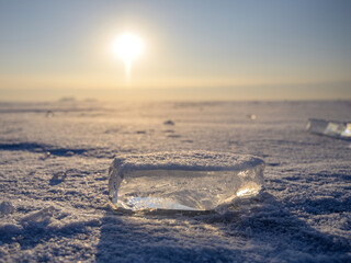 Wall Mural - an ice floe lies on the surface of a frozen lake on a sunny day