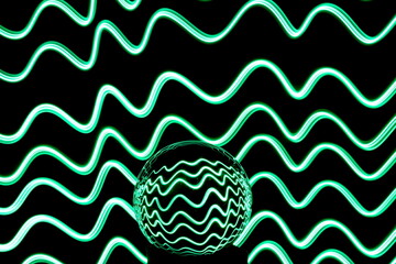 Wall Mural - Long exposure photograph of neon green colour in an abstract swirl, parallel lines pattern against a black background with reflections in a glass crystal ball. Light painting photography.
