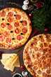 Pepperoni pizza, chorizo on a dark background, top view, flatlay