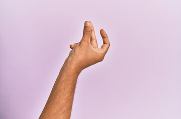 Wall Mural - Arm and hand of caucasian young man over pink isolated background snapping fingers for success, easy and click symbol gesture with hand