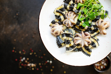 pasta ink cuttlefish seafood farfalle with baby octopus small octopuses second course snack ready to eat on the table healthy meal snack ingredient top view copy space for text food background rustic