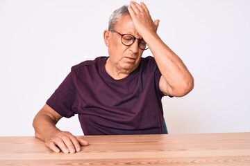 Poster - Senior handsome man with gray hair wearing casual clothes and glasses surprised with hand on head for mistake, remember error. forgot, bad memory concept.