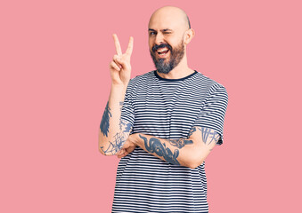 Poster - Young handsome man wearing casual clothes smiling with happy face winking at the camera doing victory sign. number two.