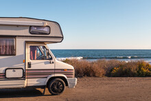 Spain; Nov 2020: Vintage Caravan Parked In Front Of The Ocean, Holidays And Freedom Feelings. Old Campervan Ready To Sleep In It. Coast Of Almería By The Mediterranean Sea, Andalusia, South Of Spain