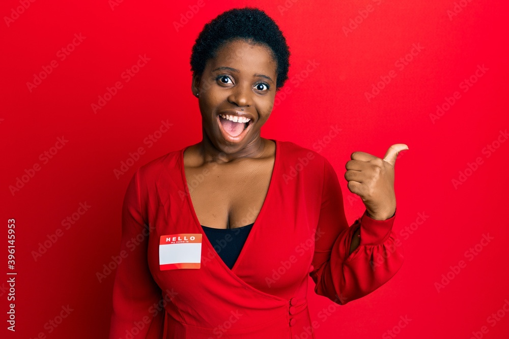 Young african woman with short hair wearing hello my name is sticker ...