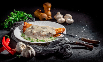 Wall Mural - Potato pancakes with mushrooms sauce, sprinkled with herbs on dark background