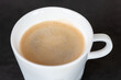 © Viktor - Black aroma coffee in the white cup on black background. Close up view