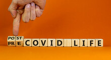 Symbol for a post-covid life. Male hand turns cubes and changes the words 'pre-covid life' to 'post-covid life'. Beautiful orange background. Medical and covid-19 pandemic concept, copy space.