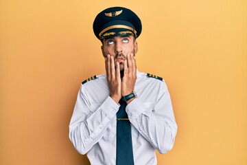 Sticker - Handsome hispanic man wearing airplane pilot uniform tired hands covering face, depression and sadness, upset and irritated for problem