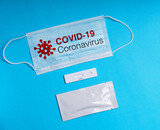 Fototapeta  - COVID-19 test to detect IgM and IgG antibodies to Novel Coronavirus, SARS-CoV-2 with positive result.Coronavirus Express Testing card. Covid-19 rapid test, on blue background. Coronavirus test. mask