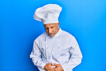 Sticker - Middle age grey-haired man wearing professional cook uniform and hat with hand on stomach because indigestion, painful illness feeling unwell. ache concept.