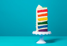 Slice Of Rainbow Cake. Delicious Multi-layered Birthday Cake.