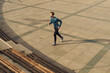 © mercankaya - Athletic and handsome young male wearing a gray mask. Young athlete wearing a mask to train outside. Fit muscular athlete dressed in sportswear wearing a mask while jogging.