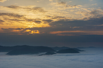 Wall Mural - Beautiful sunrise in the Carpathian mountains with fog and dramatic sky