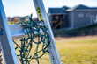 © Lost_in_the_Midwest - Selective focus on Christmas lights hanging off a ladder rung
