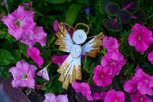 The Angel Made Of Paper  In Petunia Flowers