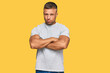 © Krakenimages.com - Handsome muscle man wearing casual grey tshirt skeptic and nervous, disapproving expression on face with crossed arms. negative person.