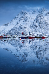 Wall Mural - boats on lofoten islands, norway. mountains and reflection on water surface. evening time. winter la
