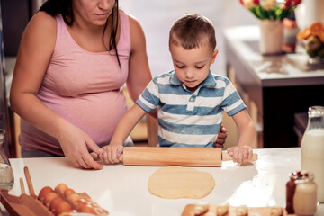 Poster - Pregnant woman and son making cookies