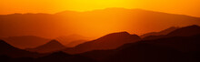 Sunset Or Sunrise In Mountains Landscape. Extra Wide Panorama Of Mountains, Wilderness And Valley On Dawn. Beautiful Dark Orange And Red Mountain Landscape With Fog. Colorful Landscape.